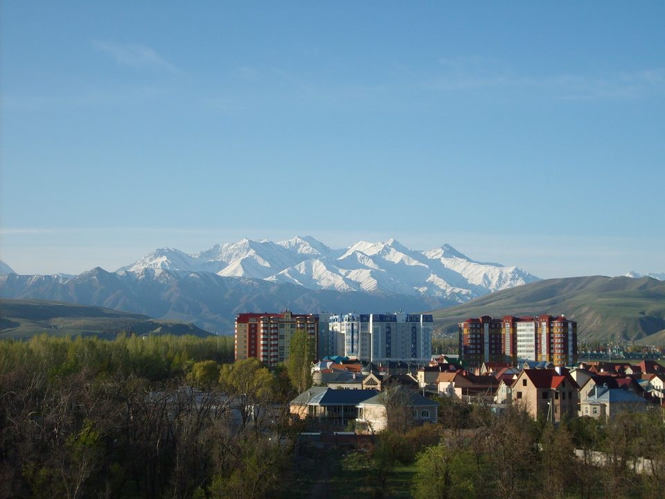 Bishkek residential districts against the snow-capped Kyrgyz Ala-Too range.