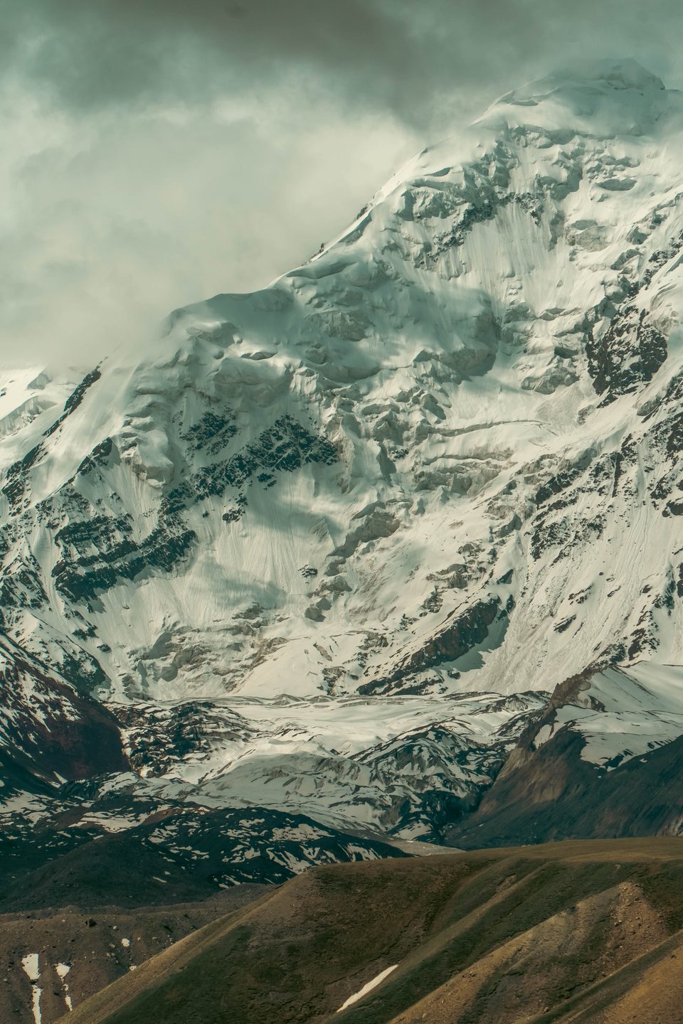 A close view of a glaciated peak in clouds above Sary-Mogol.