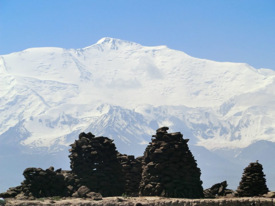 Lenin Peak behind stone ruins near Sary-Mogol.