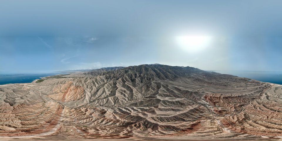 Panorama of red and ochre ridges in Skazka Canyon.