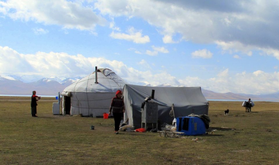 Yurt and utility tent on pasture near the shore of Son-Kul.